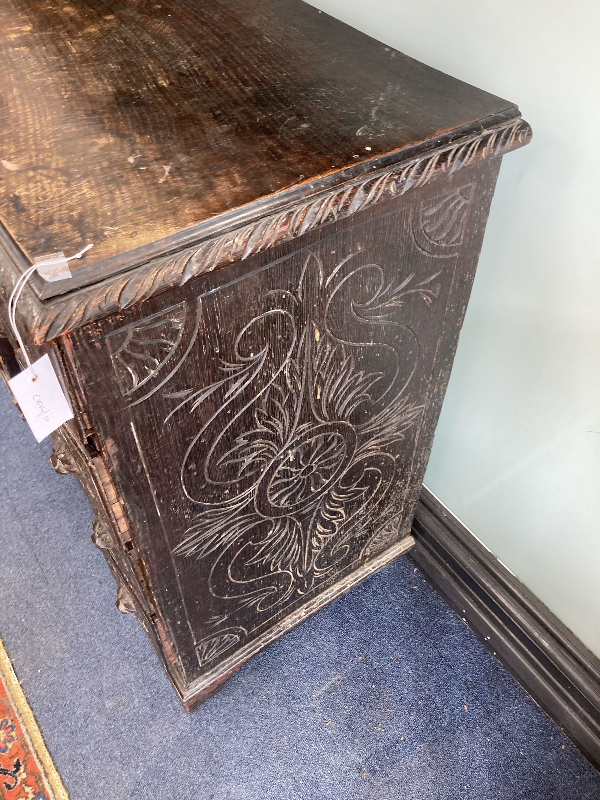 A late 19th century carved oak kneehole desk, length 94cm, depth 48cm, height 82cm